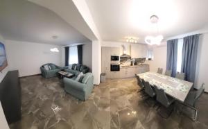a living room with a table and chairs and a kitchen at Villa Maria in Vodice