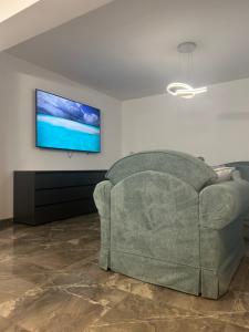 a living room with a couch and a flat screen tv at Villa Maria in Vodice