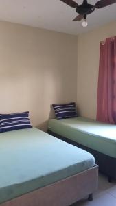 En eller flere senge i et værelse på Casa temporada