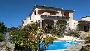a house with a swimming pool in front of it at Casa Zeralda, privater Pool in Budoni
