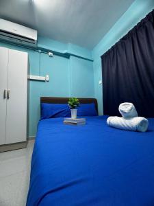 a blue bedroom with a blue bed with a stuffed animal on it at Malaysian guest only 3pax Cozy Homestay for Students & Families usm in Gelugor +18 photos