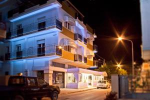 a car parked in front of a building at night at La Lanterna in Silvi Marina