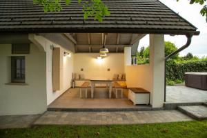 a covered patio with a table and a bench at Haus Fuchs in Tarján
