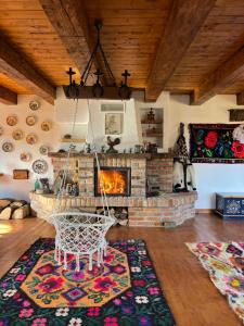 a living room with a fireplace and a swing at La Patru Daci in Ocna Şugatag +108 photos