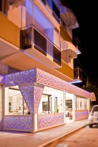 a building with blue lights on the side of it at La Lanterna in Silvi Marina
