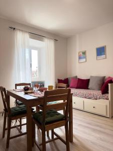 a living room with a table and a couch at Appartamento in pieno centro - La Piazzetta in Passignano sul Trasimeno