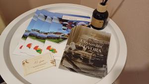 a white table with a book and a bottle of wine at Ubytovaní U Dvora in Bohumín