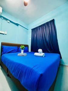 a blue bedroom with a blue bed with blue sheets at 3br 8 pax budget Malaysian guest only family stay in penang in Gelugor