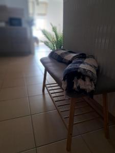 a bench with a blanket sitting on top of it at GreenStreetApartment in Kecskemét +19 photos