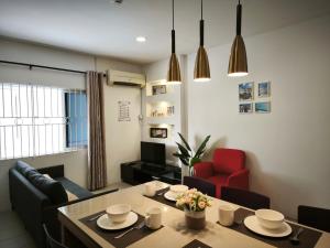 a living room with a table and a red chair at Miri Homie Homestay 2 in Miri