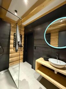 a bathroom with a sink and a mirror at Skalna Osada in Istebna