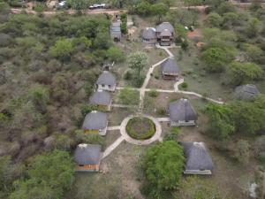 an overhead view of a group of houses with trees at Savannah Murchison Lodge in Fajao