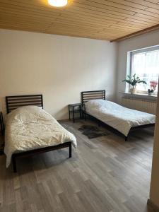 a bedroom with two beds and a window at Haus zur Alten Grube in Bexbach