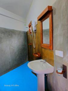 a bathroom with a sink and a window at Mountain Range Cottage in Ella +60 photos