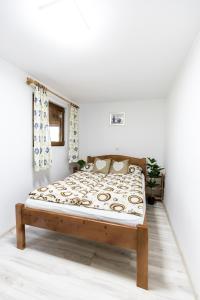 a bedroom with a bed in a white room at Wooden House Torocko-Rimetea in Rimetea