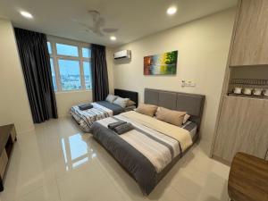 a bedroom with two beds in a room at 4 Pax - Scenic Riverfront Studio B, Kuching City in Kuching +53 photos