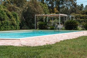 a swimming pool with a pavilion in a yard at Inghirios Wellness Country Resort in Santa Maria la Palma