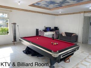 a living room with a pool table in it at Villa Puncak Resort Cipanas in Cikundul