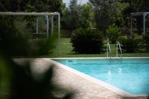 a swimming pool in a yard with at Inghirios Wellness Country Resort in Santa Maria la Palma