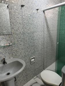 a bathroom with a shower and a sink and a toilet at New Point Hotel in São Paulo +25 photos