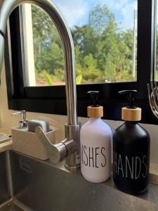 two bottles of hand sanitizers sitting next to a sink at High-In Holiday Home&Villa in Ko Phangan +36 photos