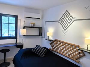a bedroom with a bed and a desk and a window at Playa de la Fuente in Lajita +35 photos