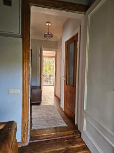 a hallway with a door leading into a house at White House Apartment in Jūrmala