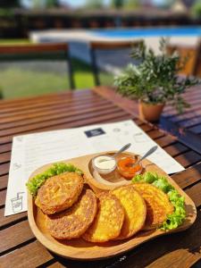 a plate of food on a wooden table at Casa Tomșa in Rozavlea