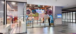 a store front with balloons and a person standing in a mall at Supercozy kids-theme #4 Walk to i-City Park & Mall in Shah Alam +22 photos