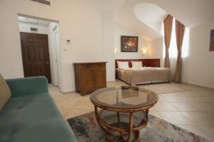 a living room with a couch and a table at Hotel CENTRAL Balchik in Balchik