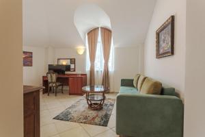 a living room with a couch and a table at Hotel CENTRAL Balchik in Balchik