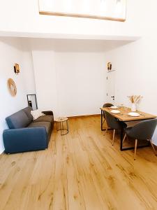 a living room with a couch and a table at Fly Residence 2 in Arad