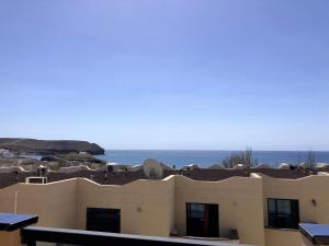 a view of a building with the ocean in the background at Playa de la Fuente in Lajita