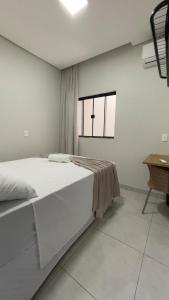 En eller flere senge i et værelse på Hospedagem Palhares