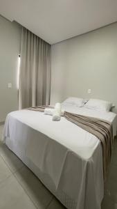 En eller flere senge i et værelse på Hospedagem Palhares