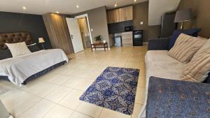 a living room with a bed and a couch at Belle Vie Boutique Guesthouse in Pretoria