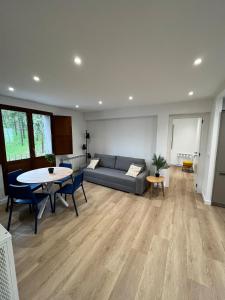 a living room with a couch and a table at AtuaireHome Cabestreros a un paso de la catedral y el Castillo in Burgos