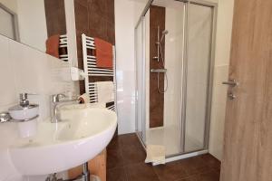 a bathroom with a sink and a shower at Ferienhaus Wöscher in Kaltenbach +47 photos