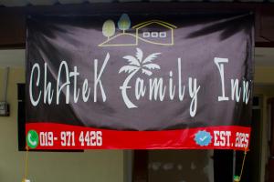 a sign that says charleston community on a banner at Chatek Family Inn in Kampong Pasir Hantu