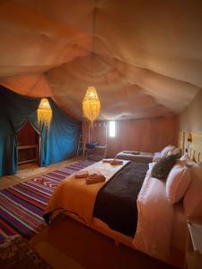 a bedroom with a large bed in a tent at Pulse Desert Camp in Merzouga +50 photos
