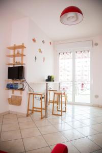 a living room with a table and chairs and a tv at House 30 meters from the sea with gated parking in Marina di Montenero