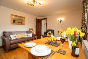 a living room with a table and a couch at Ystumgwern Luxury Barn Conversions in Dyffryn