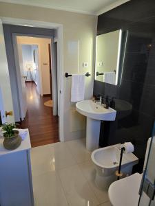 a bathroom with a sink and a toilet at Green Seaty View in Ponta Delgada