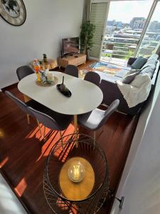 a living room with a table and chairs and a couch at Green Seaty View in Ponta Delgada