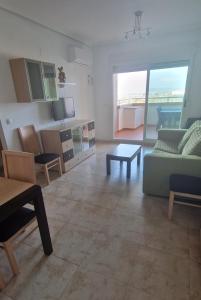 a living room with a couch and a table at Apartamento Magic World, nueva Marina Dor, Jardines del Mar III- Oropesa del Mar in El Borseral