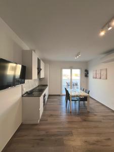 a kitchen with a table and a dining room at Attico sulla Riserva in San Benedetto del Tronto