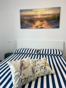 a bed with a sign on it with two birds on it at Attico sulla Riserva in San Benedetto del Tronto