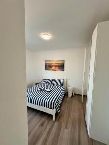 a bedroom with a bed and a painting on the wall at Attico sulla Riserva in San Benedetto del Tronto +24 photos