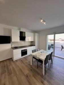 a kitchen and dining room with a table and chairs at Attico sulla Riserva in San Benedetto del Tronto