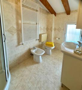 a bathroom with a toilet and a sink at Open space centre in Lignano Sabbiadoro +19 photos